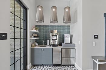 A kitchen with blue cabinets and a coffee maker on the counter